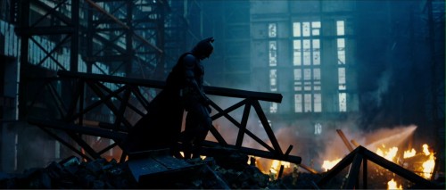 Batman stands on rubble