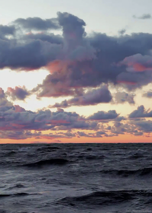 massive waves under pink and purple clouds.gif