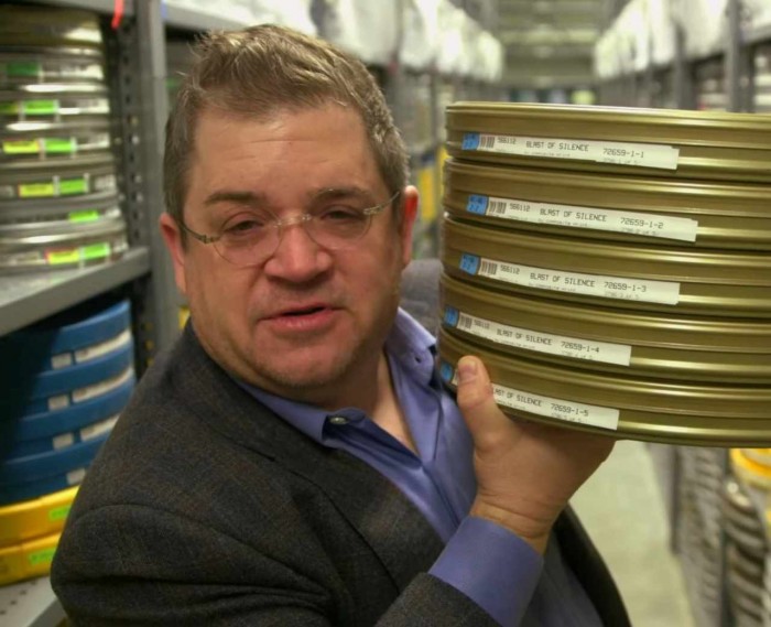 Patton Oswalt with some movie reels.jpg