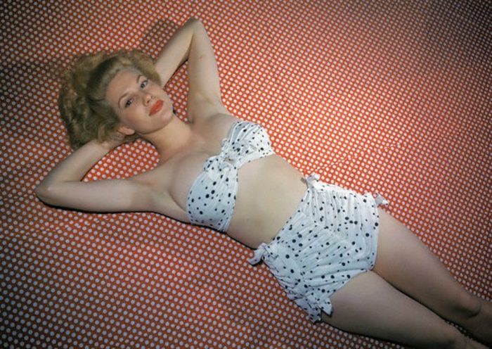 Famous Model Chili Williams Wearing Polka Dot Bikini and Lying on Dotted Red and White Fabric --- Image by © Bettmann/CORBIS