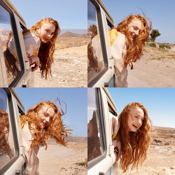 Sophie Turner hanging out of a car.jpg
