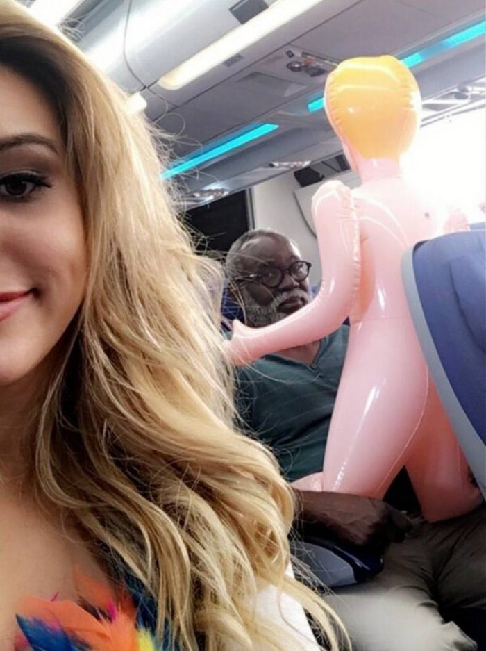 airline passenger with blow up doll.jpg