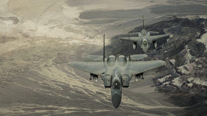 two fighter jets over mountains.jpg