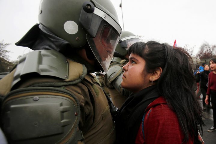 demonstrator stares down a riot policeman.jpg