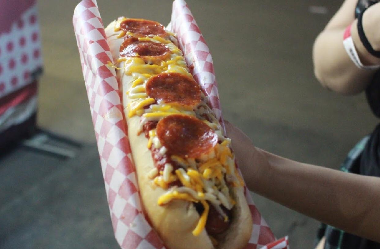 a Footlong Hotdog wrapped in bacon topped with marinara cheese and