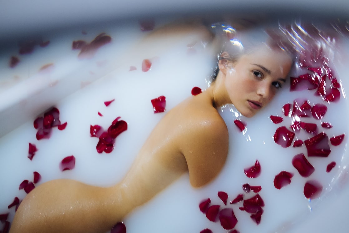 alba baptista in a bathtub with milk and roses.