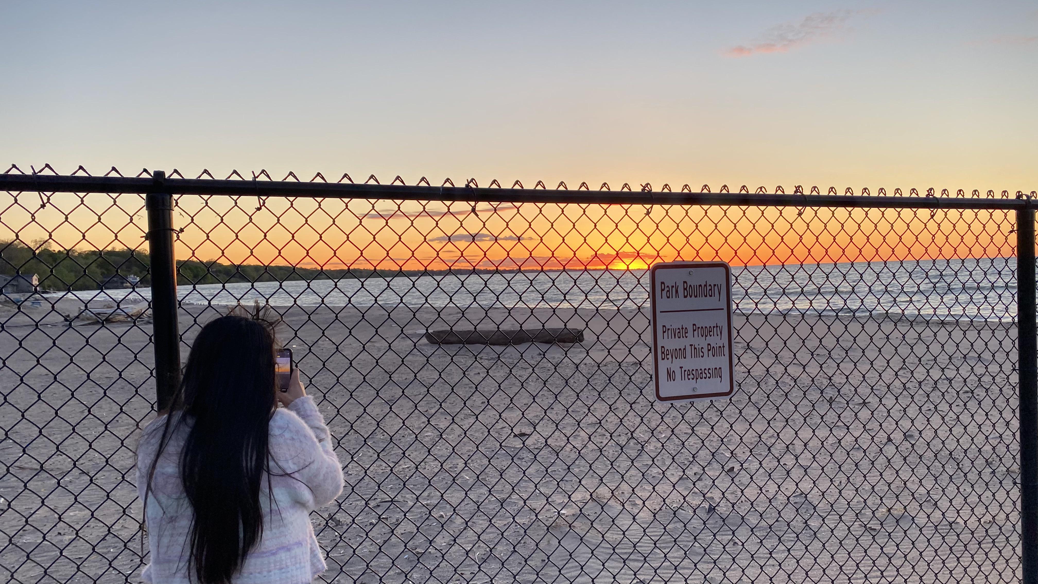 Our local park’s beach: chain link fence separates our romantic evening from sunset